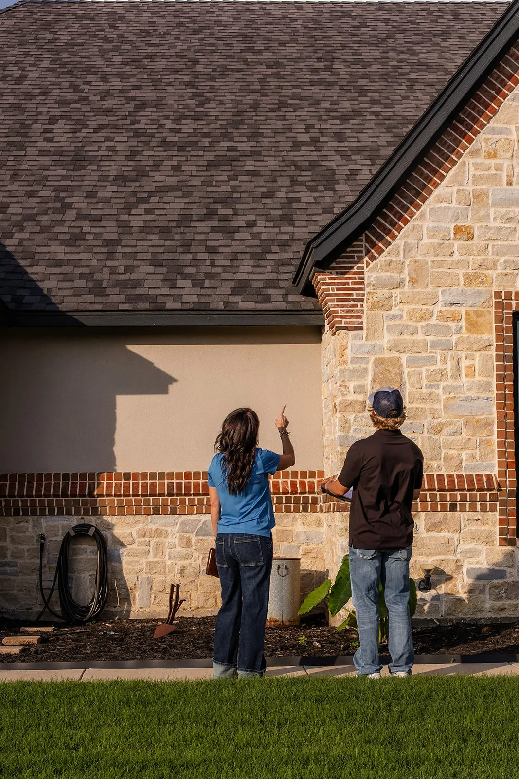A-Custom team inspecting a home foundation in the evening light